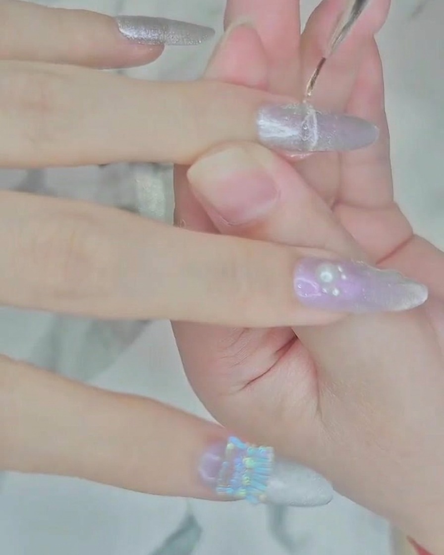 A fine detailing brush applying a thin line of clear builder gel to the nail near the cuticle.