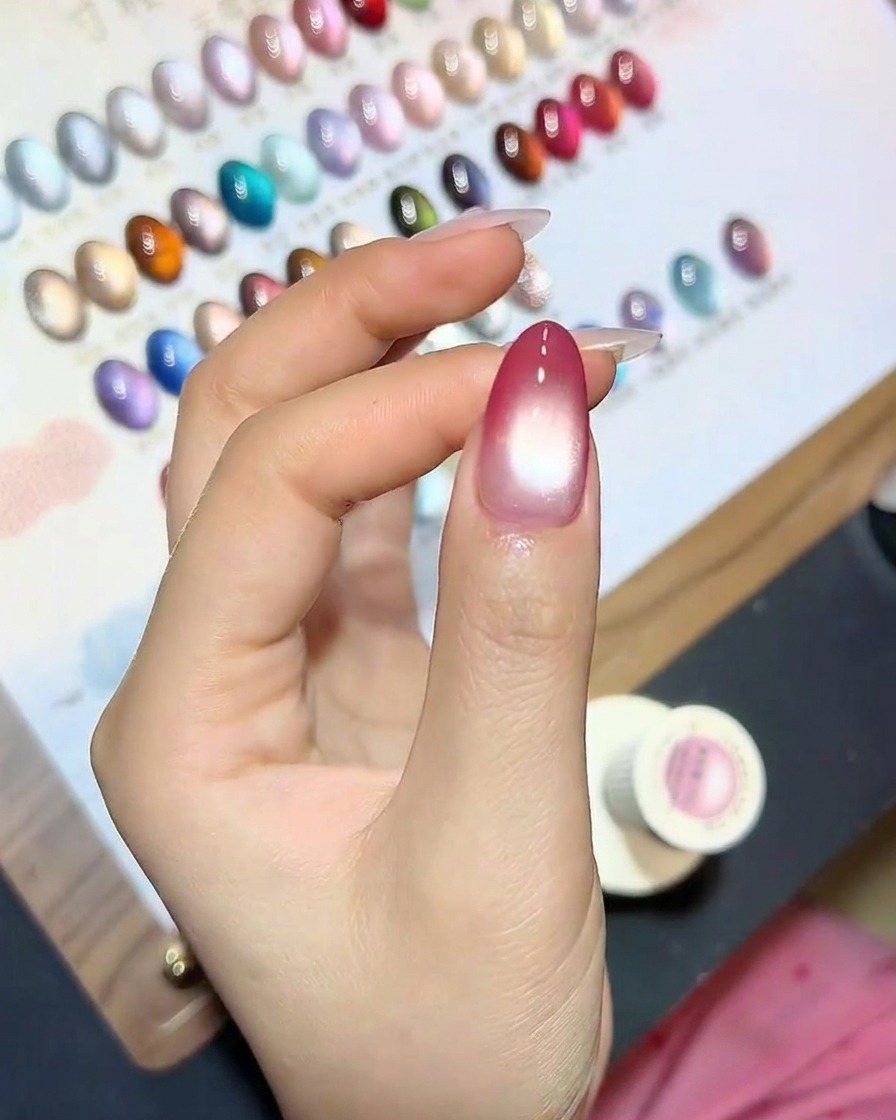 A fingernail with the cat-eye effect being cured under a UV lamp.