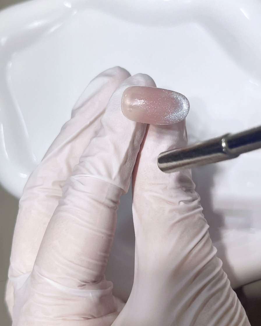 A close-up of a brush applying a second layer of shimmering gel to perfect the gradient look.