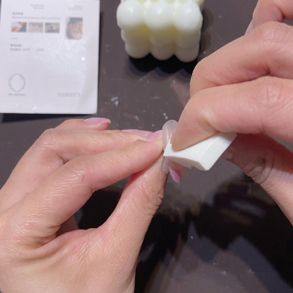 An ombre brush sweeping upwards to blend the second white layer into the pink base.