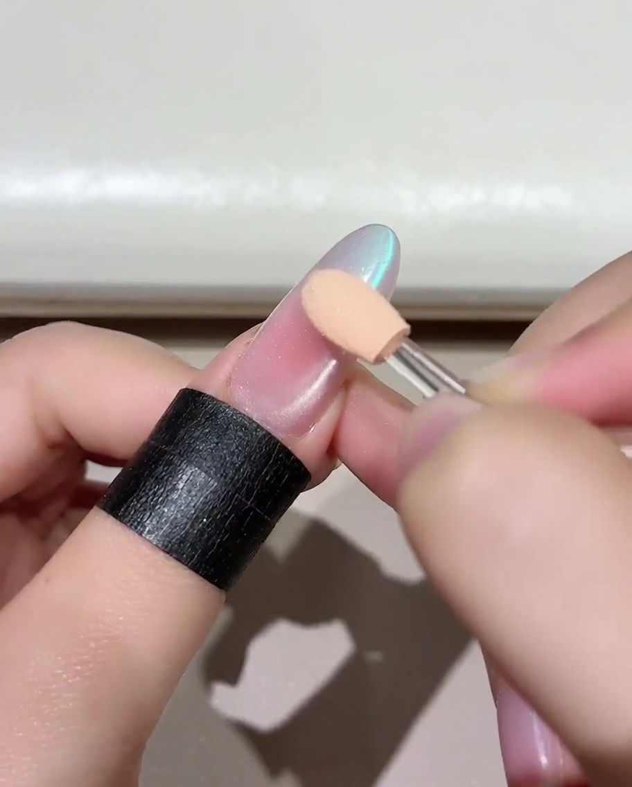 A brush applying a vibrant layer of Jade D05 gel polish onto a prepped nail.