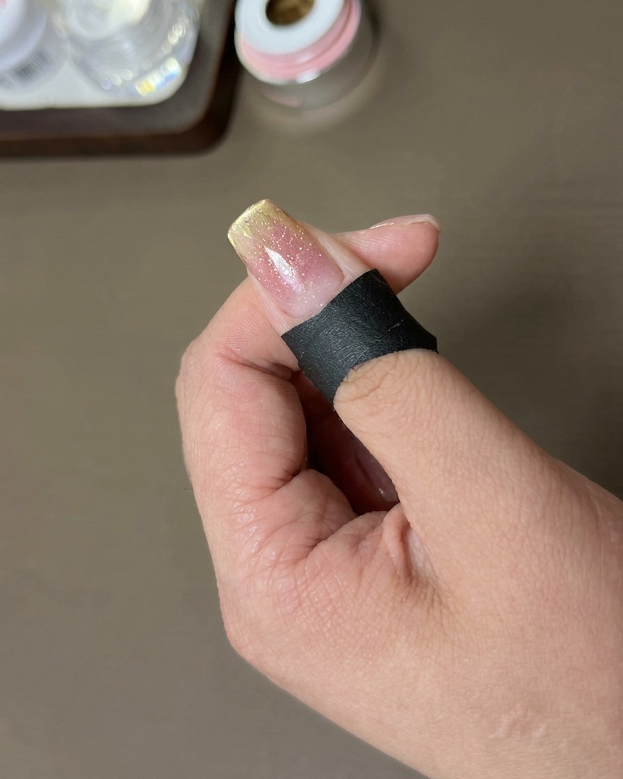 A rectangular magnet positioned at the tip of the nail to create a sharp magnetic French-tip line.