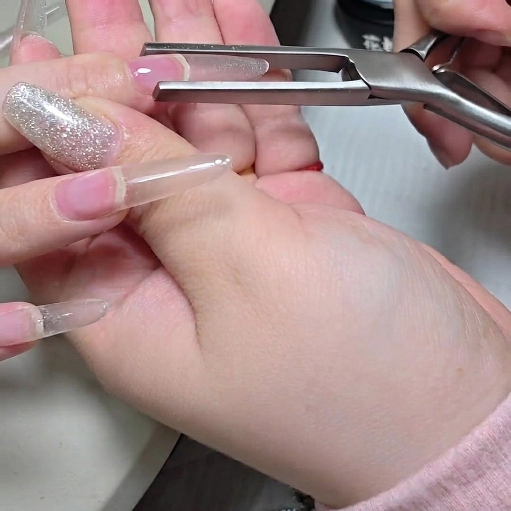 A flat gel brush applying a second layer of builder gel onto the nail, building up the structure.