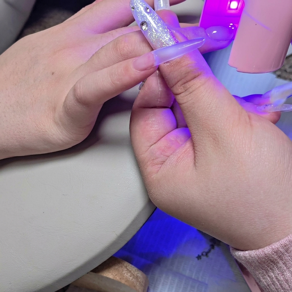 A mini UV/LED lamp placed over the nail to flash cure the second layer of builder gel.