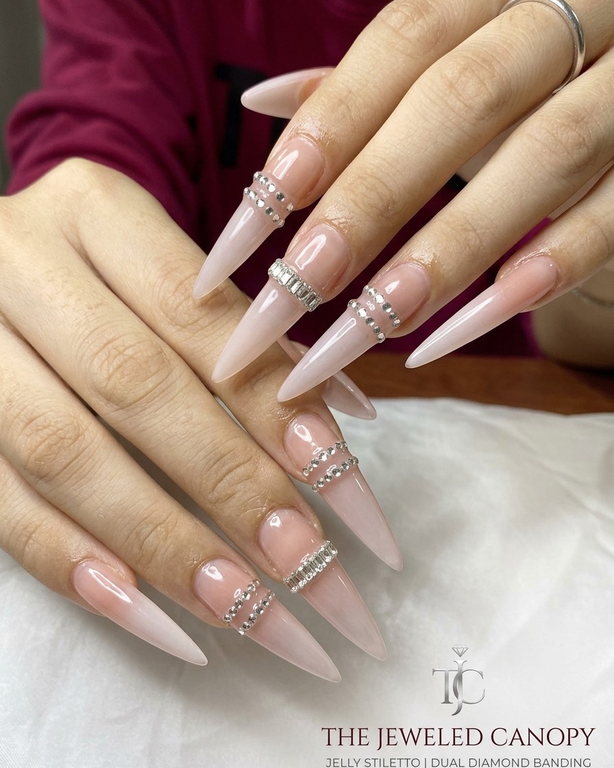 A hand applying a press-on nail extension to the next finger.