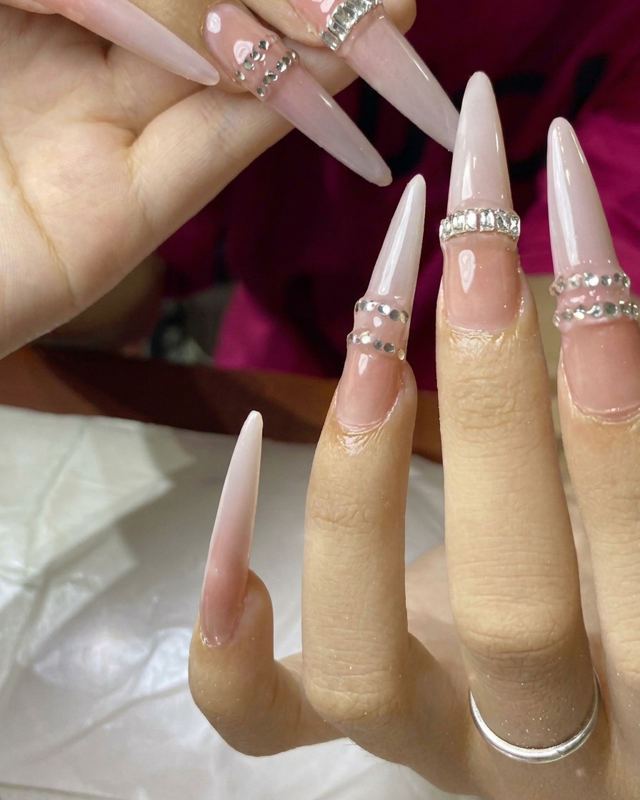 A hand resting inside a UV nail lamp, with nails undergoing a final cure.