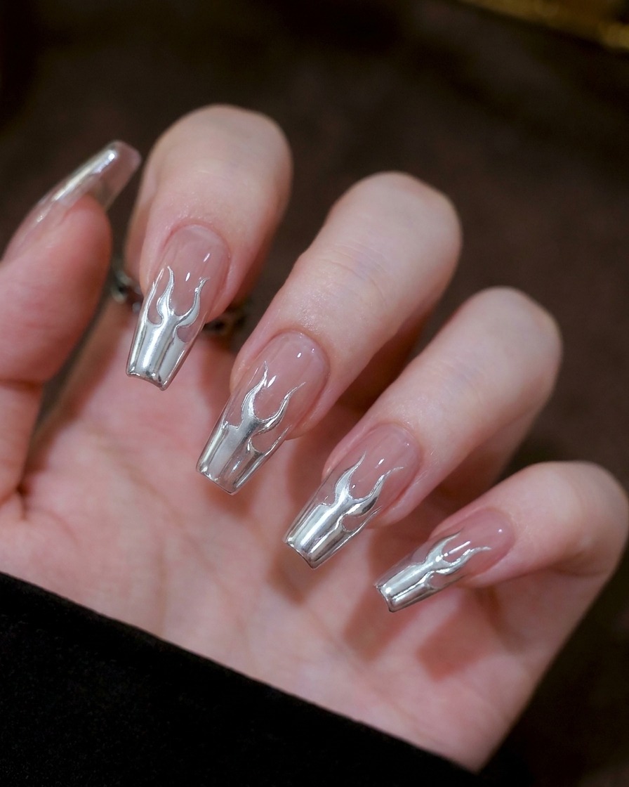 A close-up showing two small, symmetrical U-shaped silver gel markings in the center of a nail.