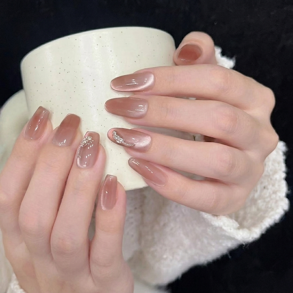 A close-up showing the base of a press-on nail being aligned perfectly with the natural cuticle area.