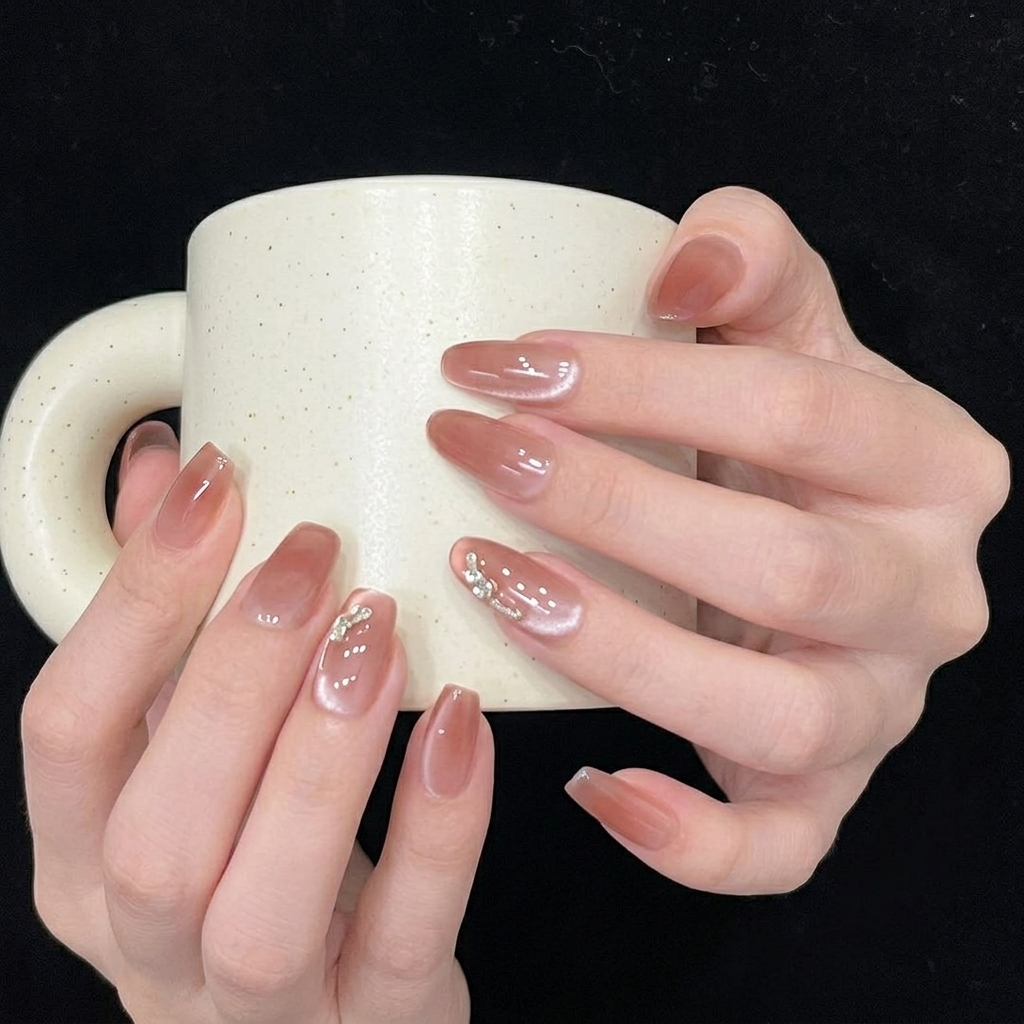 A close-up side-view of a press-on nail showing a seamless, smooth fit against the natural cuticle.