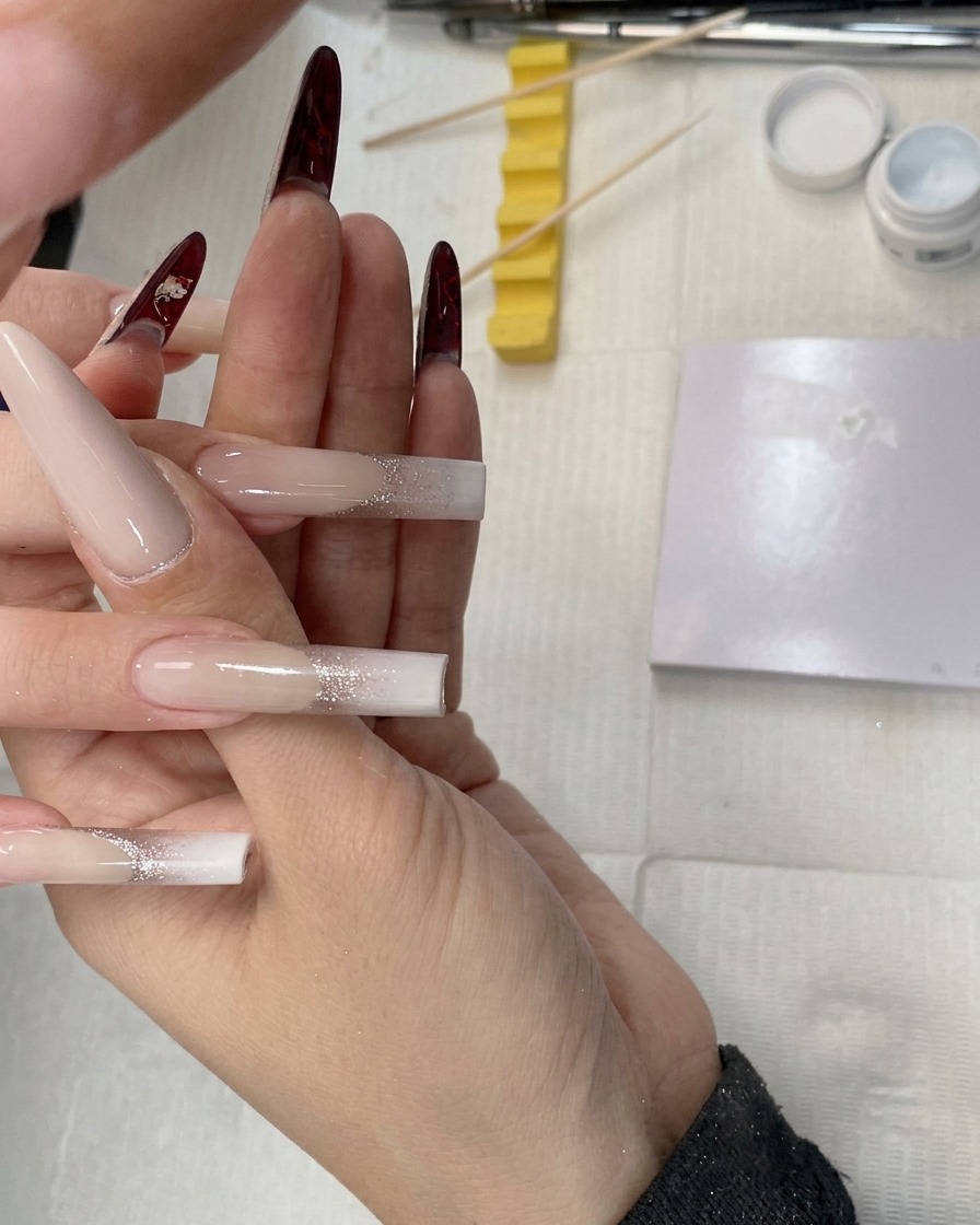 A close-up of a sponge tool being used to pat white gel onto the tip of a water pipe square-shaped nail.