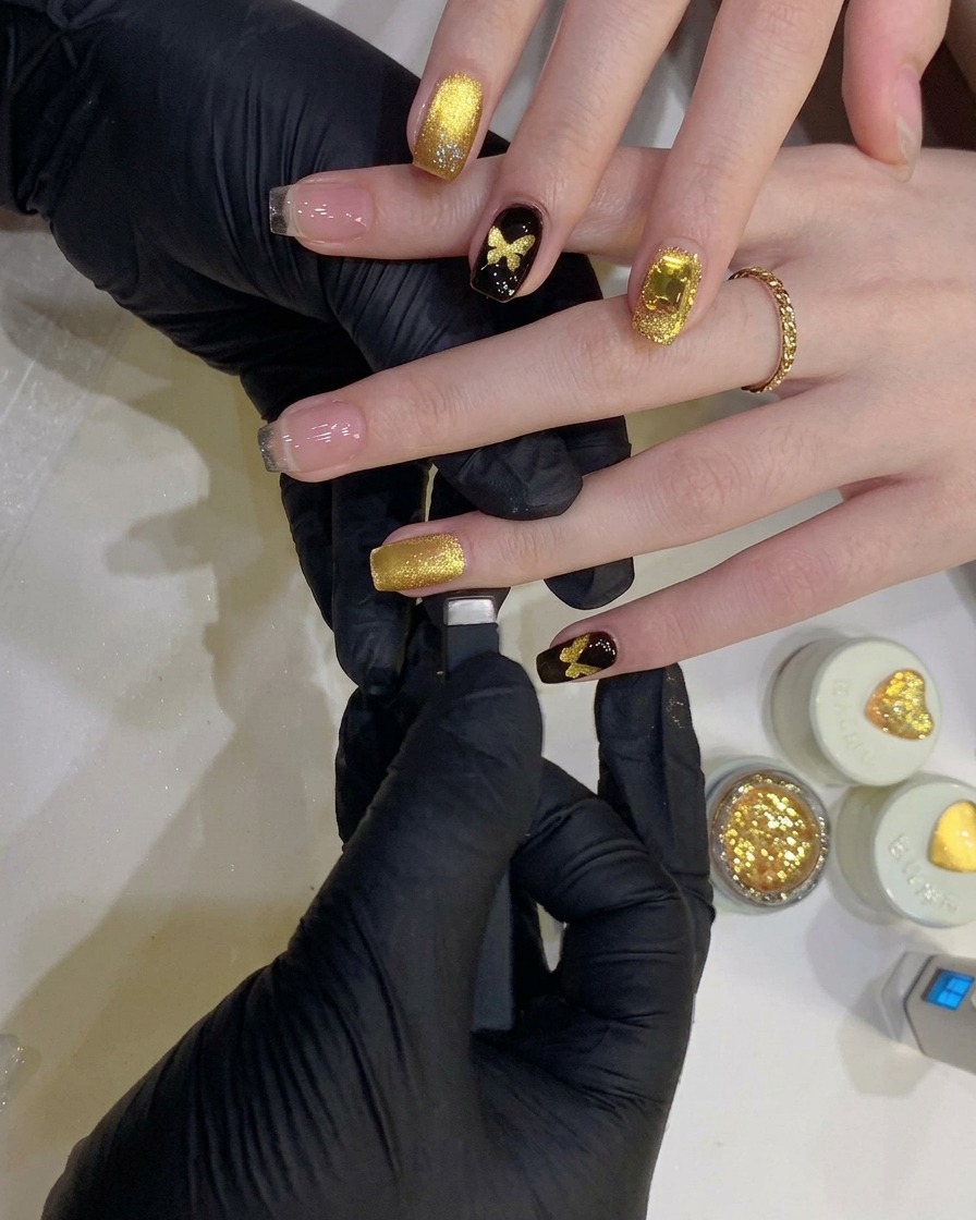 A close-up of a precision round magnet tool being used to create a concentrated shimmer spot on a nail.