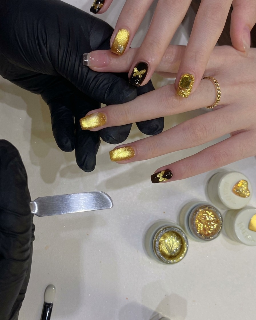 A hollow butterfly stencil being centered and pressed onto a nail surface.