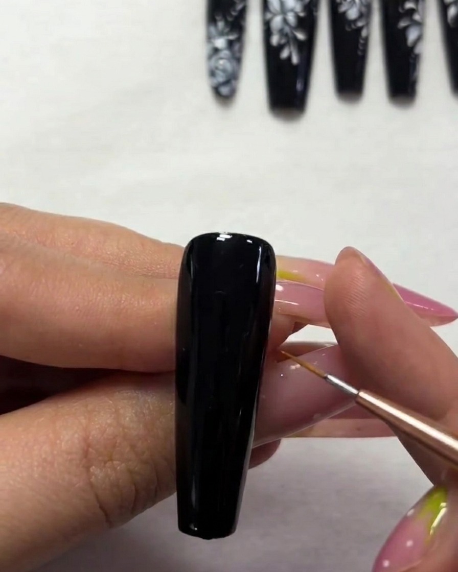 A macro shot focusing on the refinement of the smaller butterfly wings with precise white paint strokes.