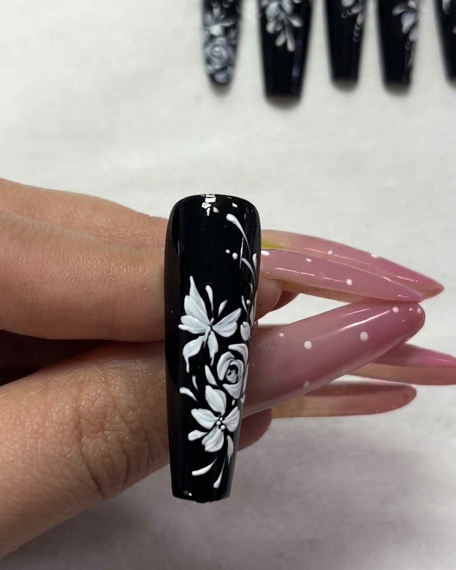 A manicured nail being placed inside a UV lamp for curing.
