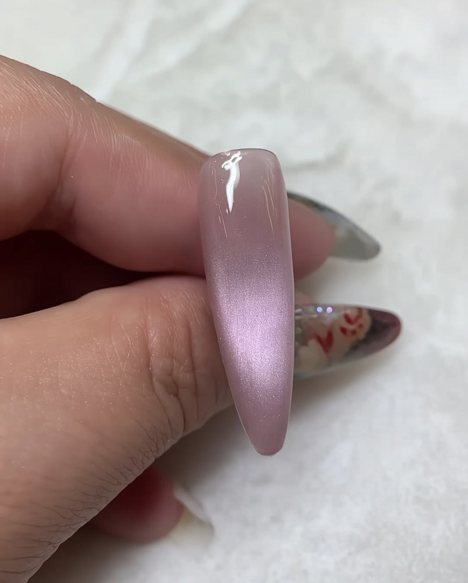 A fine liner brush drawing two symmetrical diagonal lines outward from the top of the central body line on the nail.