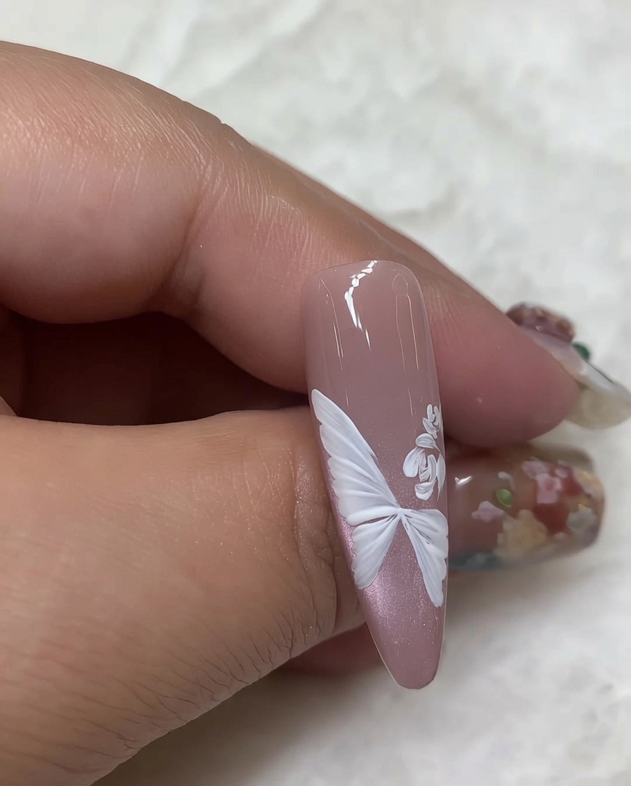 Close-up showing layers of white curved brush strokes being added to form detailed rose petals.