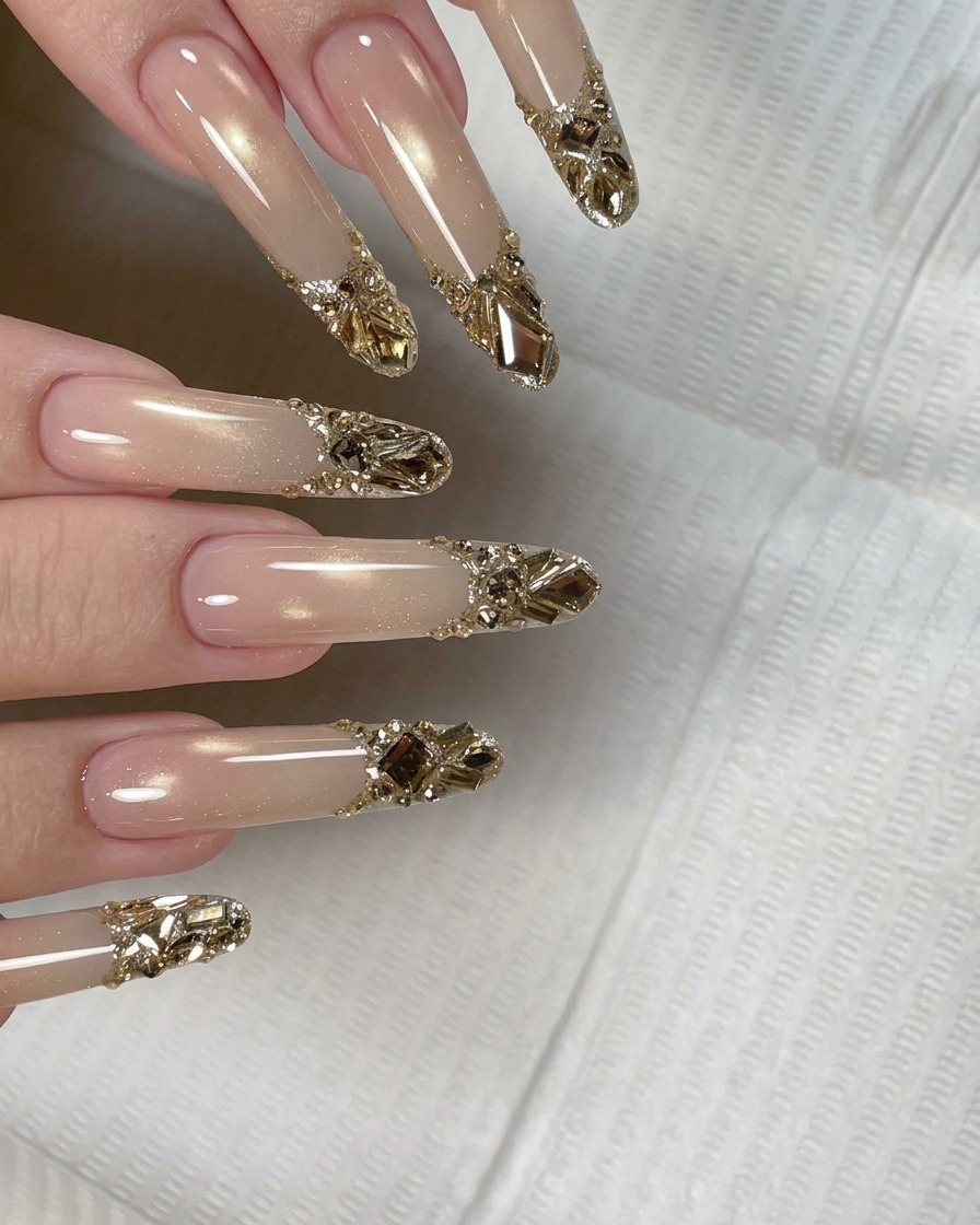 A nail brush applying a clear, glossy top coat over a nail decorated with crystals and a glitter tip.