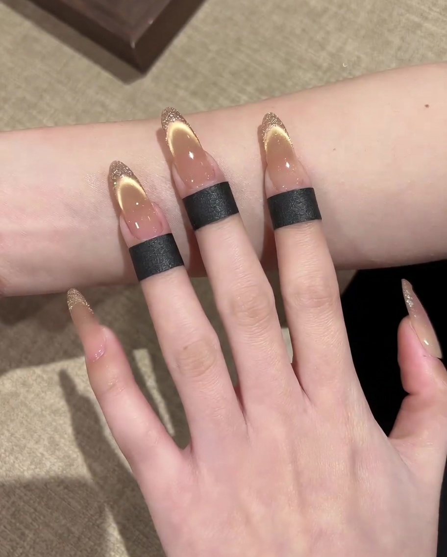 A close-up of a brush smoothing a second layer of nude base gel onto the nail.