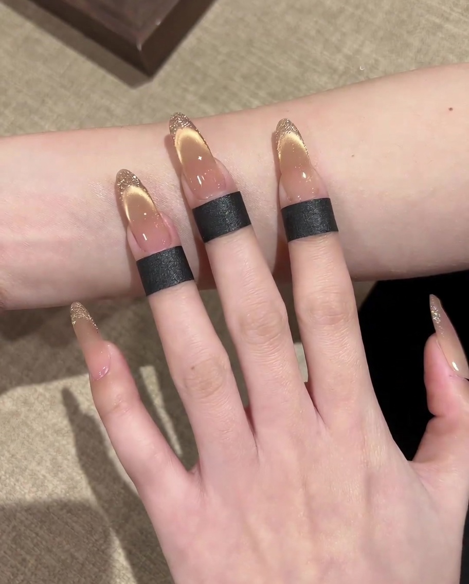 A square magnet being used at an angle to sharpen the magnetic shimmer into a French tip shape.