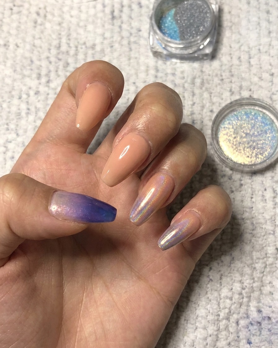 Dabbing holographic pigment onto the tip of an index finger.