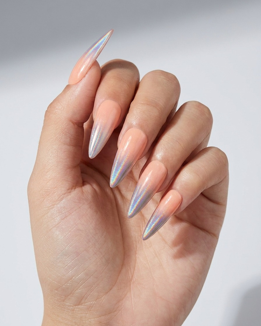 A close-up of a brush applying a clear gel layer over a nail with a holographic chrome ombre gradient.
