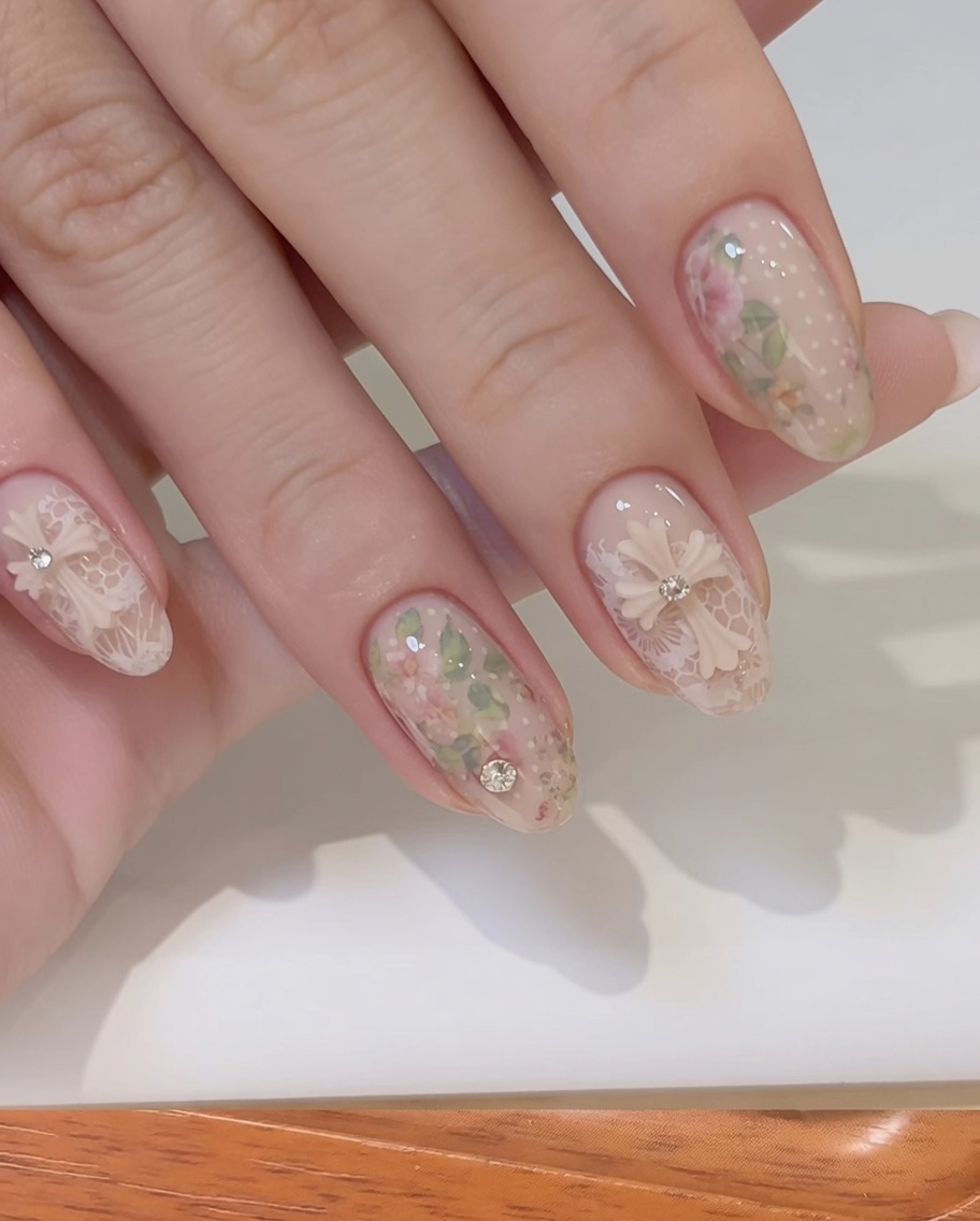 A fine-tipped brush smoothing out builder gel around a 3D bow charm on a fingernail.