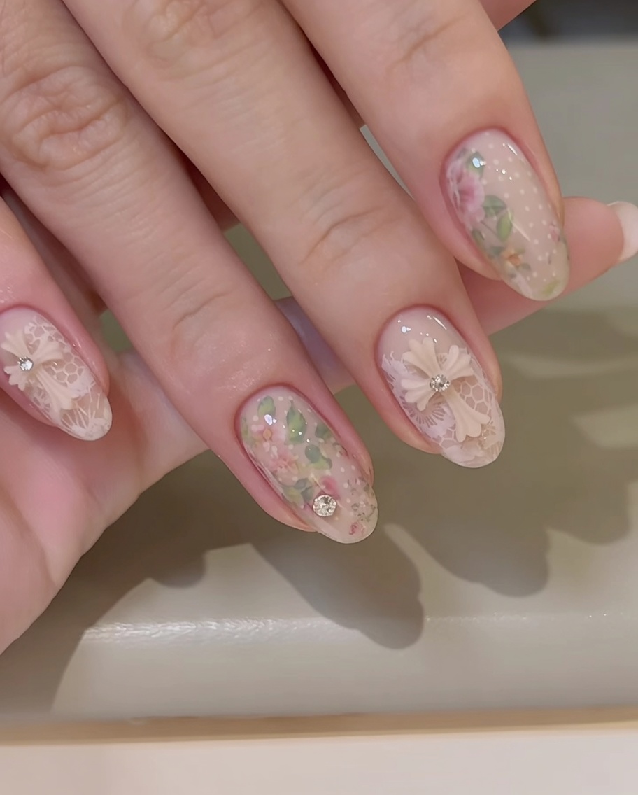 A top coat brush applying clear gel across the nail, carefully avoiding the surface of the 3D bow charm.