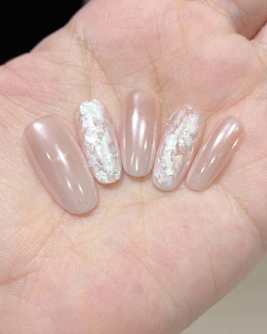 A macro shot of a liner brush detailing white cloud-like patterns on a nail surface.