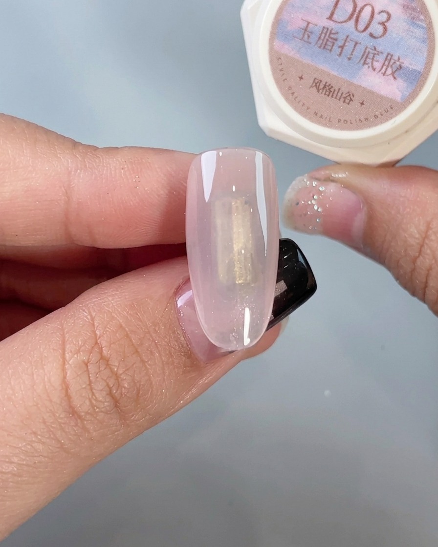 A nail brush applying a clear top coat specifically designed for use with chrome powder.