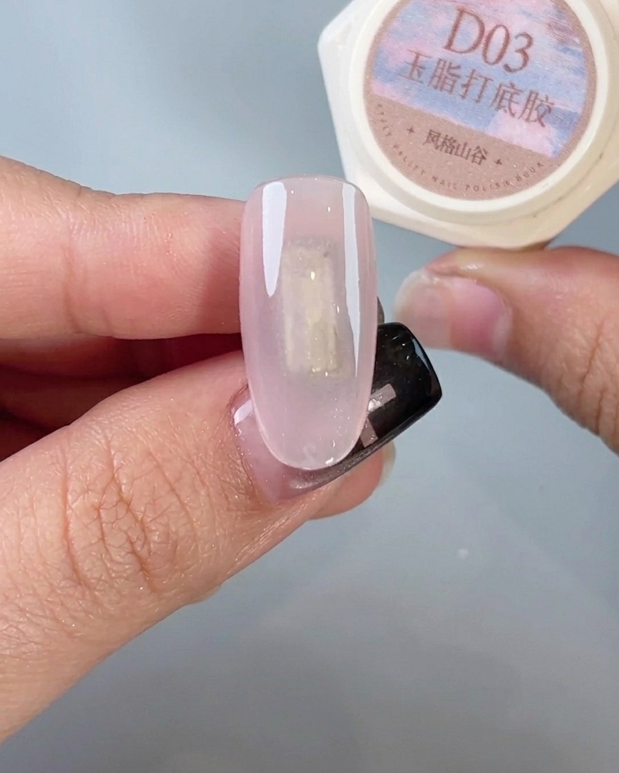 A nail brush applying a final, glossy top coat to a finished chrome nail.