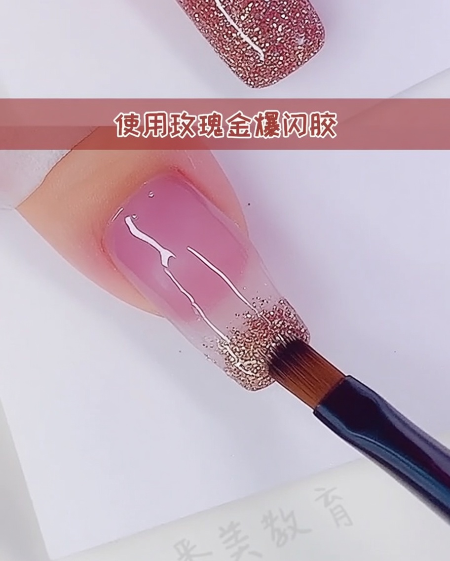 A close-up of a brush adding a second layer of rose gold glitter to intensify the gradient.