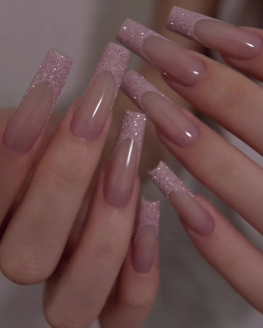 A close-up shot showing the smooth transition and even surface between the pink base and the glitter tip during slight hand movement.