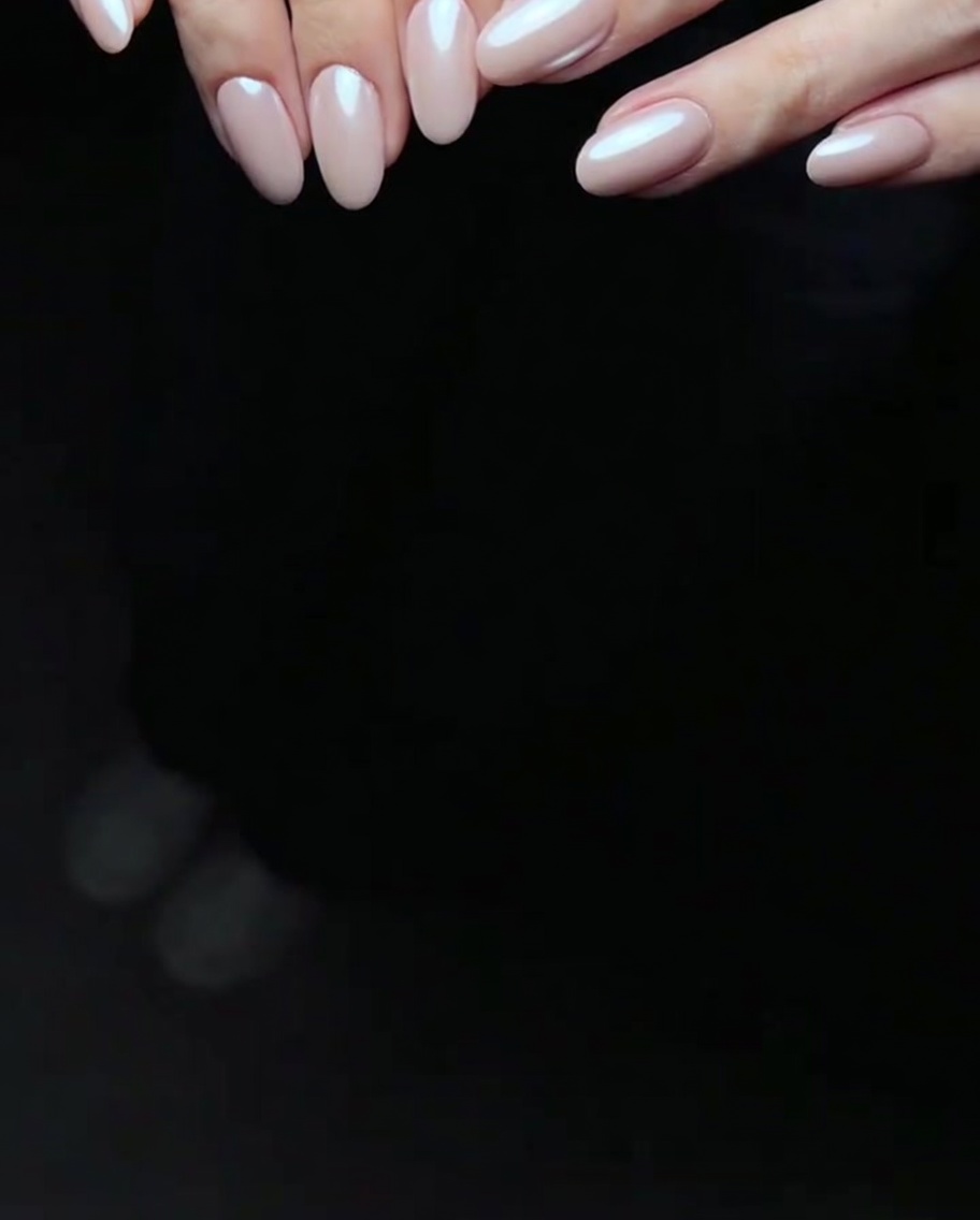 A hand resting inside an LED nail lamp, with the fingers visible under the curing light.