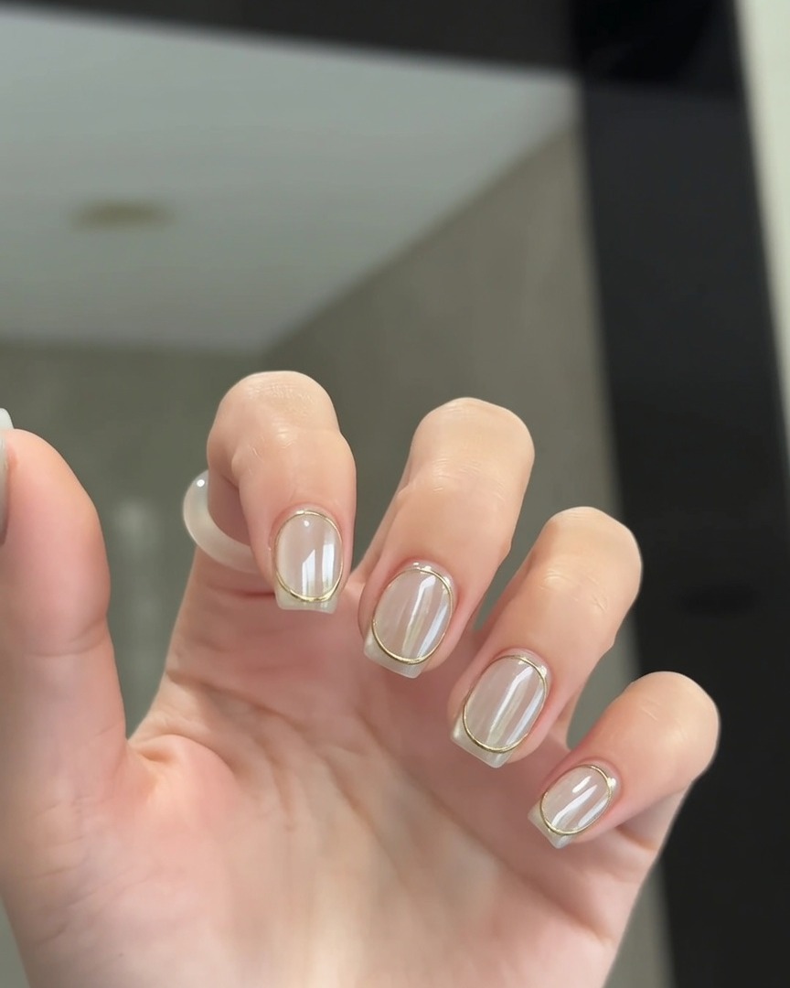 A hand resting under a UV/LED nail lamp for the final cure.