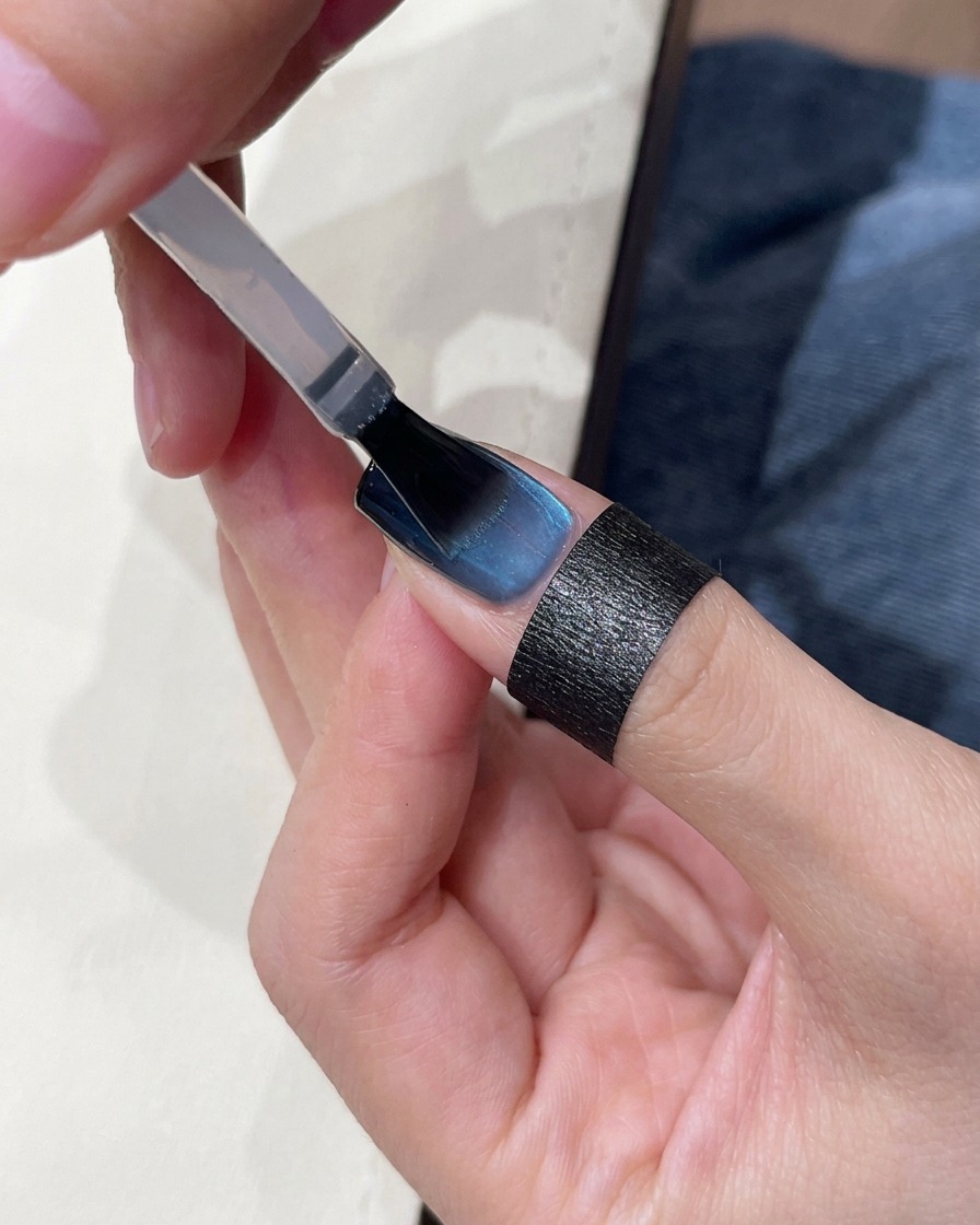 Applying top coat to the finished nail.