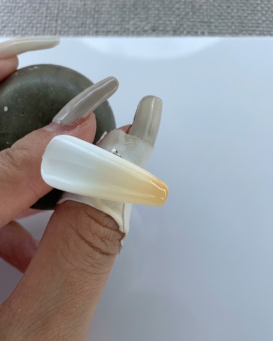 A brush applying clear top coat over the finished airbrushed gradient.