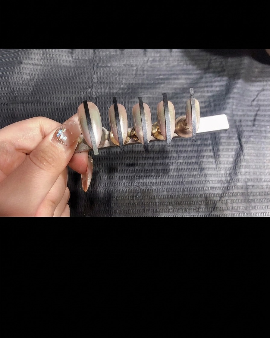 A hand placing the nail stand inside a UV curing lamp.