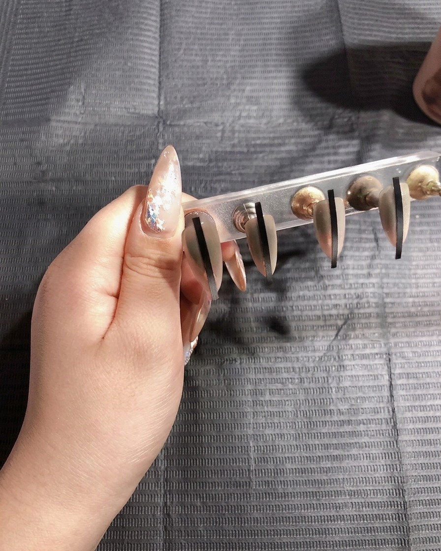 The nails curing under the UV lamp for the second time.