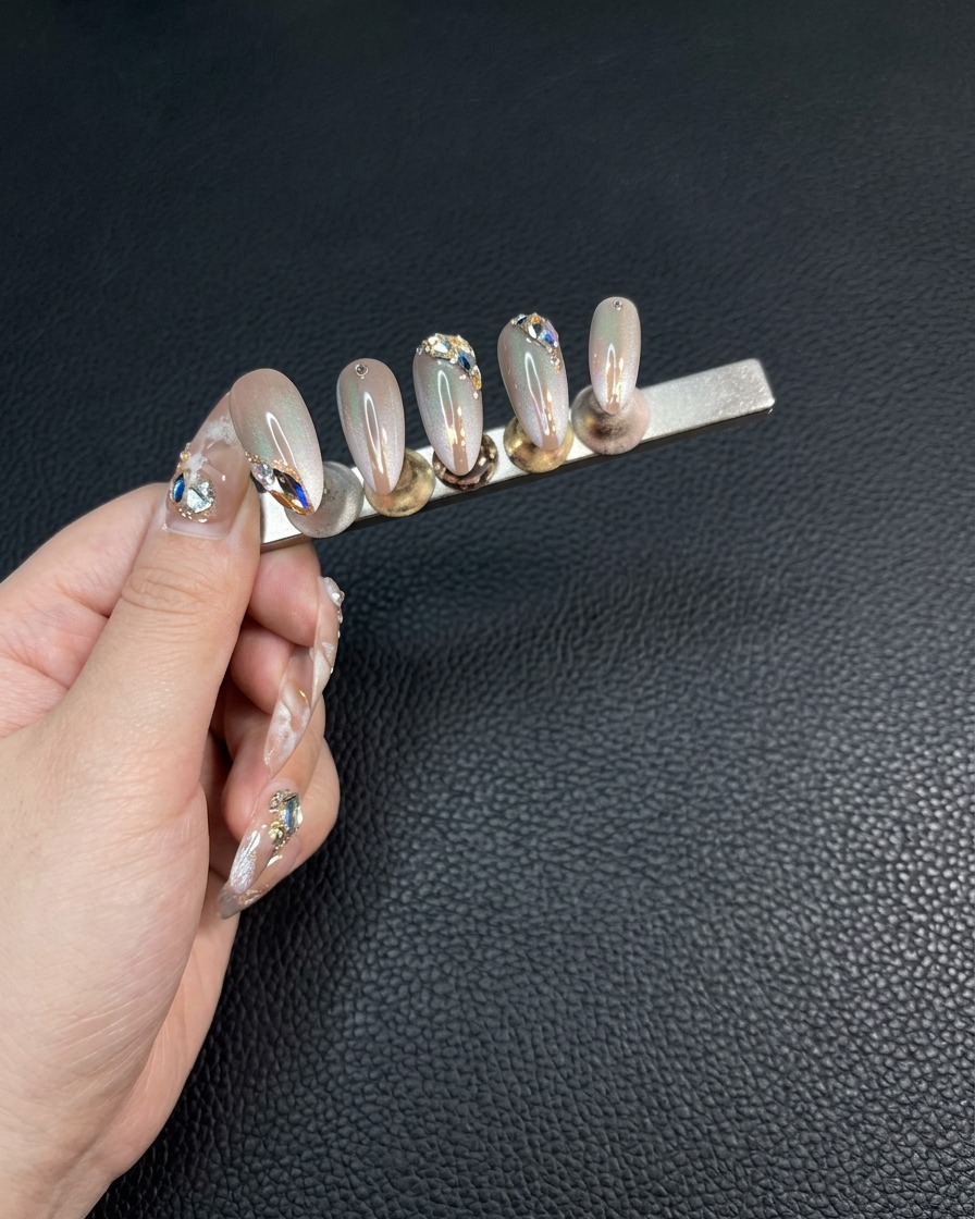 Close-up of fingers holding a nail stand, refining the edges of the second set of nails with a small file.