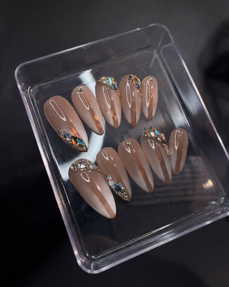 A macro view showing the glossy, reflective surface of the finished nails with top coat applied.