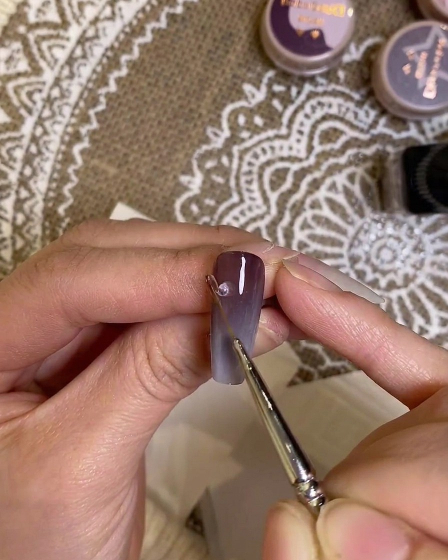 A close-up view of the completed gradient nail being inspected for final quality.