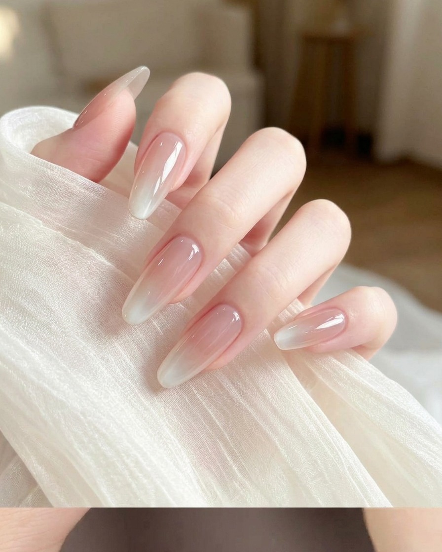 A makeup sponge with a small amount of white gel polish applied to its corner.