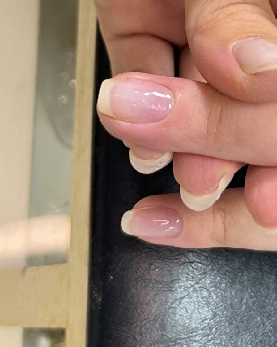 A small bead of clear construction gel placed in the center of the nail plate, ready for leveling.