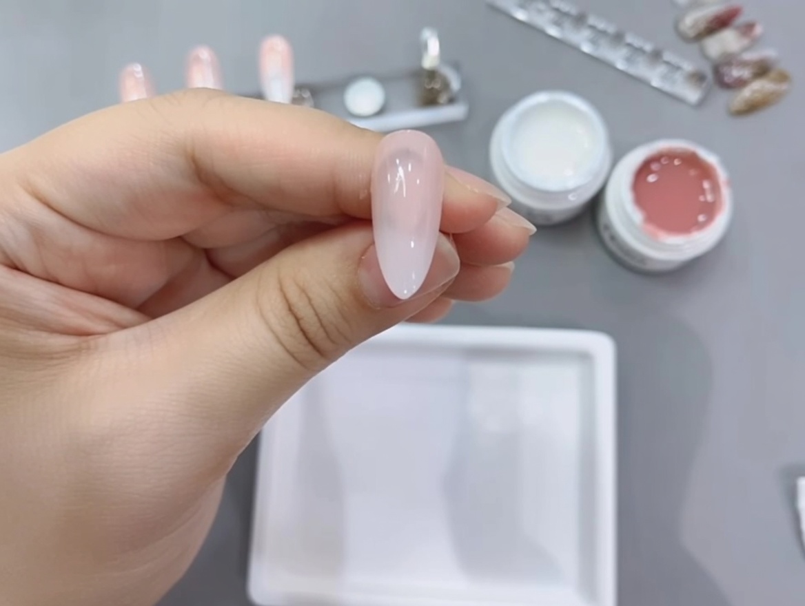 A nail tip with the completed gradient being cured under the lamp.