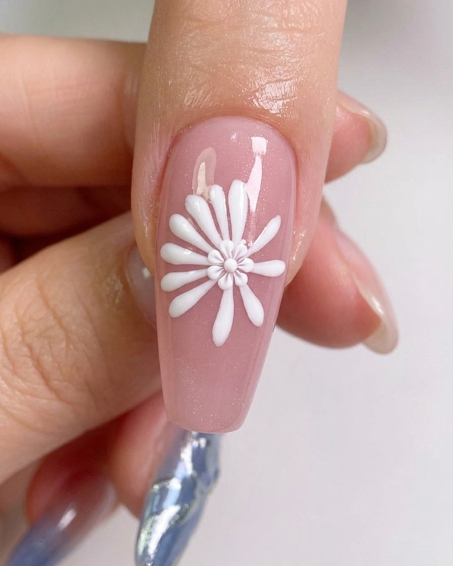 A close-up view showing additional white lines being drawn between the initial guide lines to create a fuller daisy petal effect.