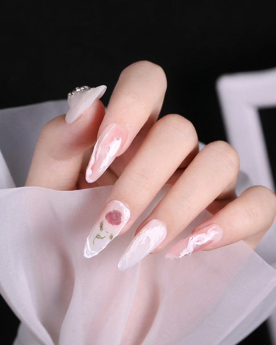 A detail brush concentrating a deeper red color into the center of a rose nail design.