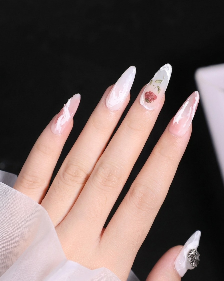 A close-up of a middle finger showing a textured white gel swirl extending down the side of the nail.