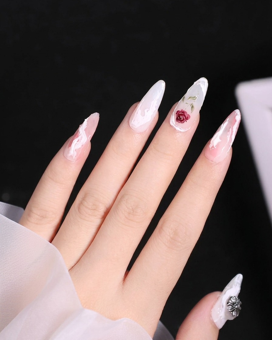 Close-up of a nail with a wavy white raised gel line being drawn down the side of the nail bed.