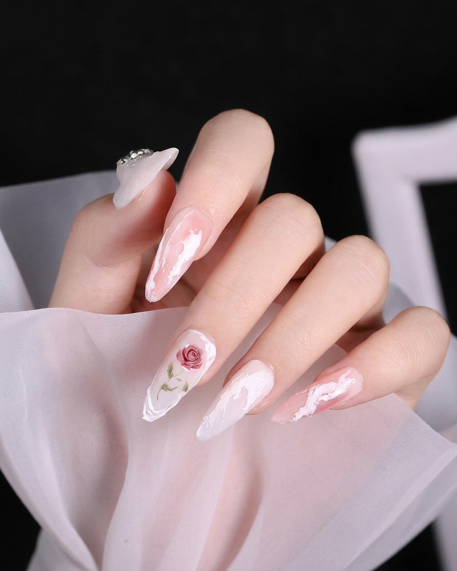 A close-up shot of a pinky finger with a diagonal 3D white gel line on the tip.