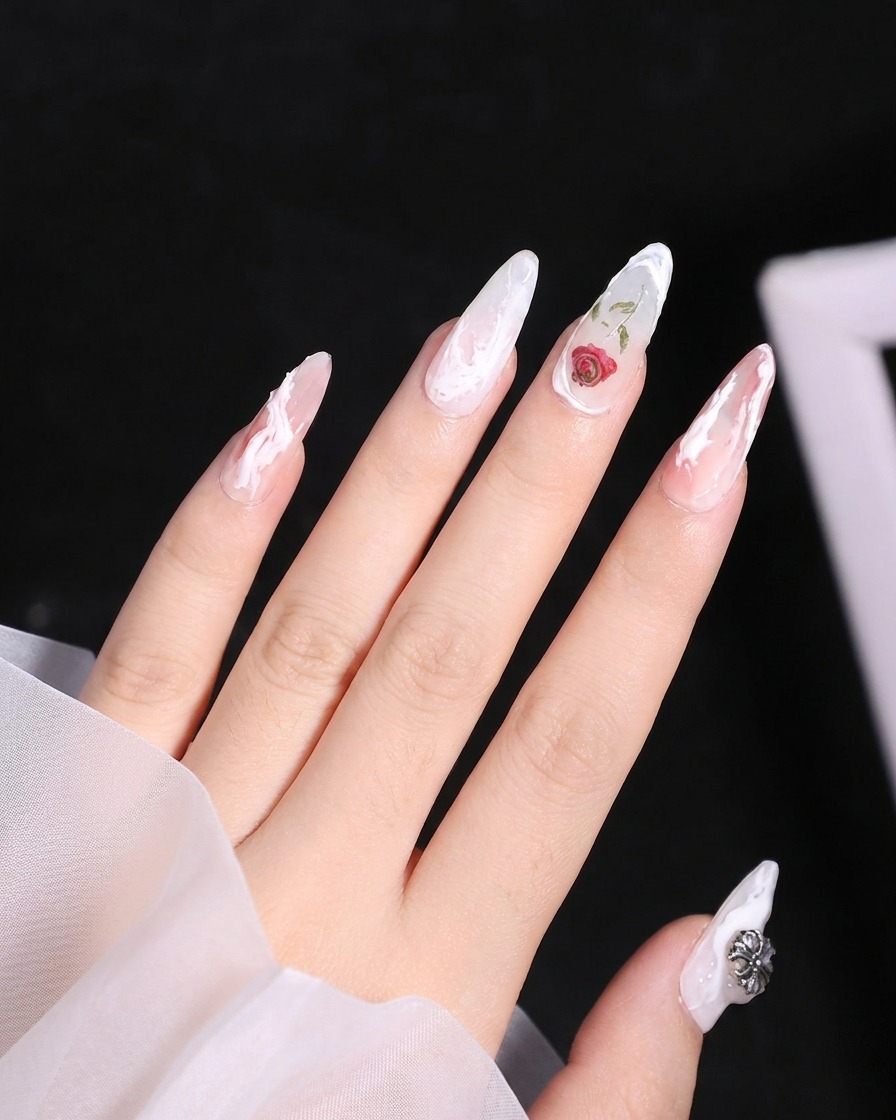 A close-up view of a thumb nail receiving a sweeping 3D white line application along the left edge.